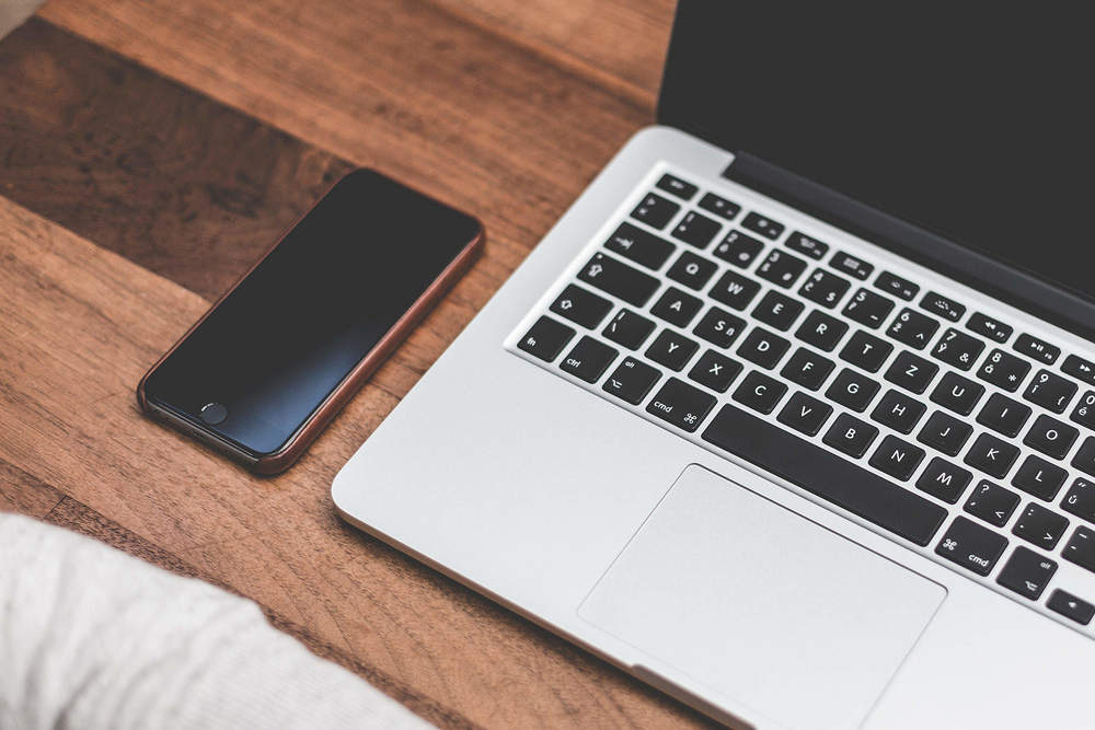 Smartphone next to laptop